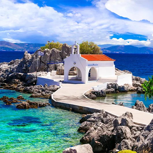 A scenic view of little church in the sea over the rocks A scenic view of little church in the sea over the rocks