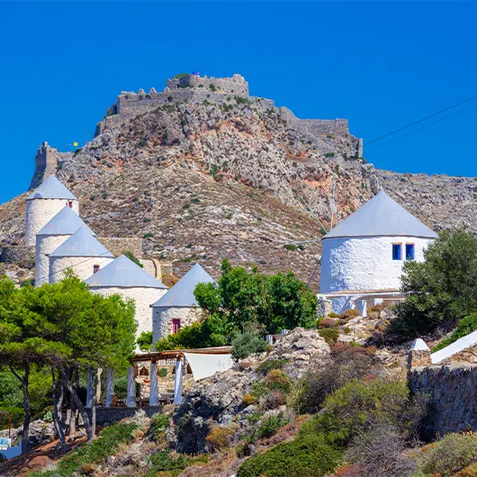 A scenic view of windmills and castle of Panteli in Leros island A scenic view of windmills and castle of Panteli in Leros island