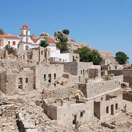 A scenic view of the abandoned village of Mikro Chorio on the Greek island of Tilos A scenic view of the abandoned village of Mikro Chorio on the Greek island of Tilos
