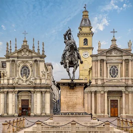 A scenic view of Emmanuel Philibert in St Charles square and twins churches of Santa Cristina and Sant Carlo A scenic view of Emmanuel Philibert in St Charles square and twins churches of Santa Cristina and Sant Carlo
