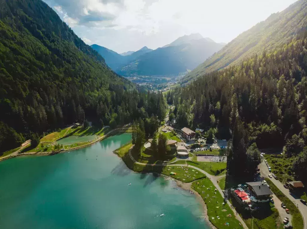 Green trees reflected in the water of Lac Montriond in France