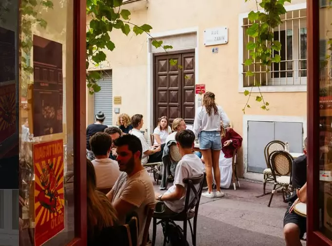 Young people gathering outside La Treille Bar a Vin in Nice, France