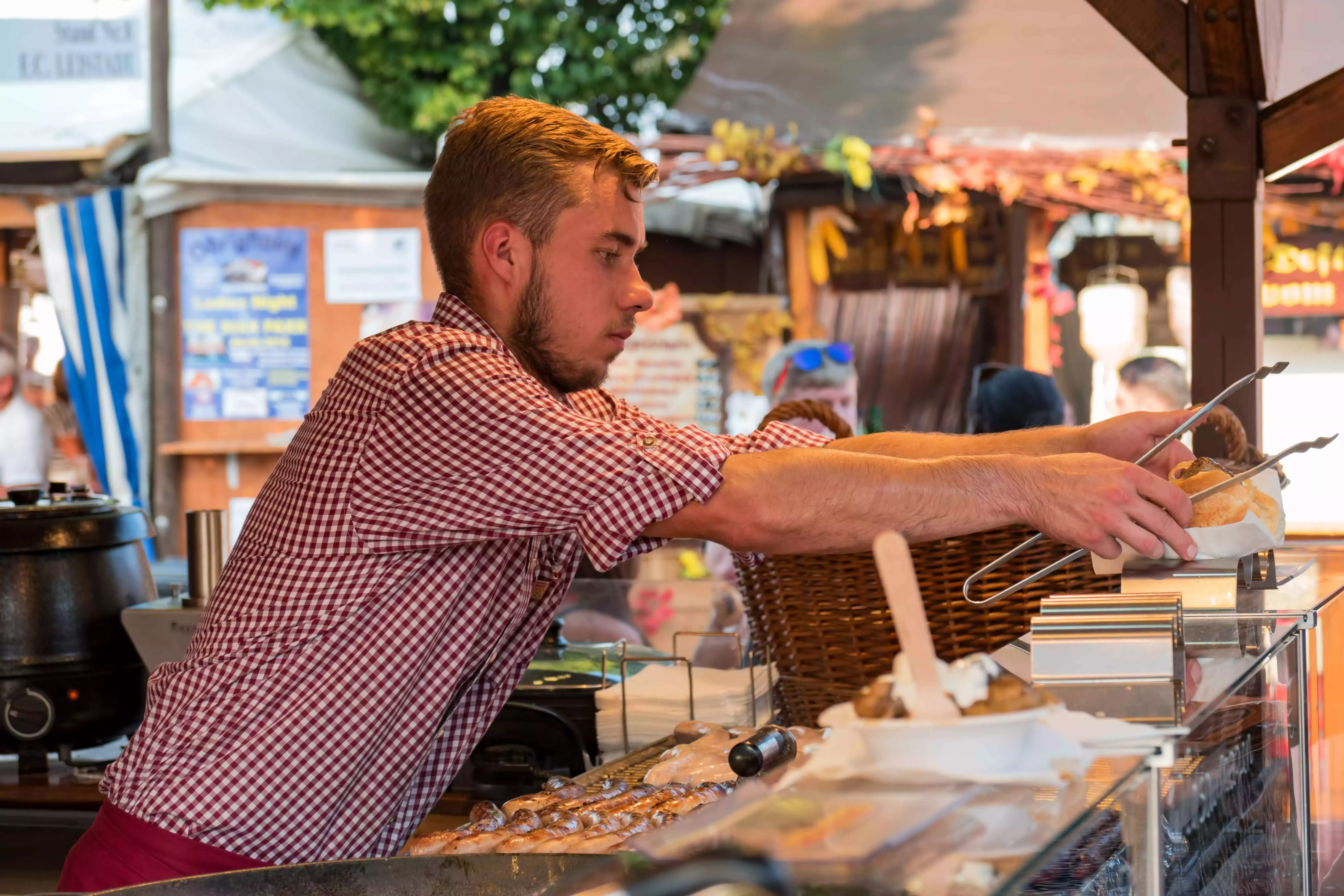 A street-food vendor grilling German wursts at the Wurstmarkt festival in Germany.