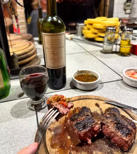 A bite of excellent steak with a bottle of malbec at Don Niceto parrilla, Buenos Aires