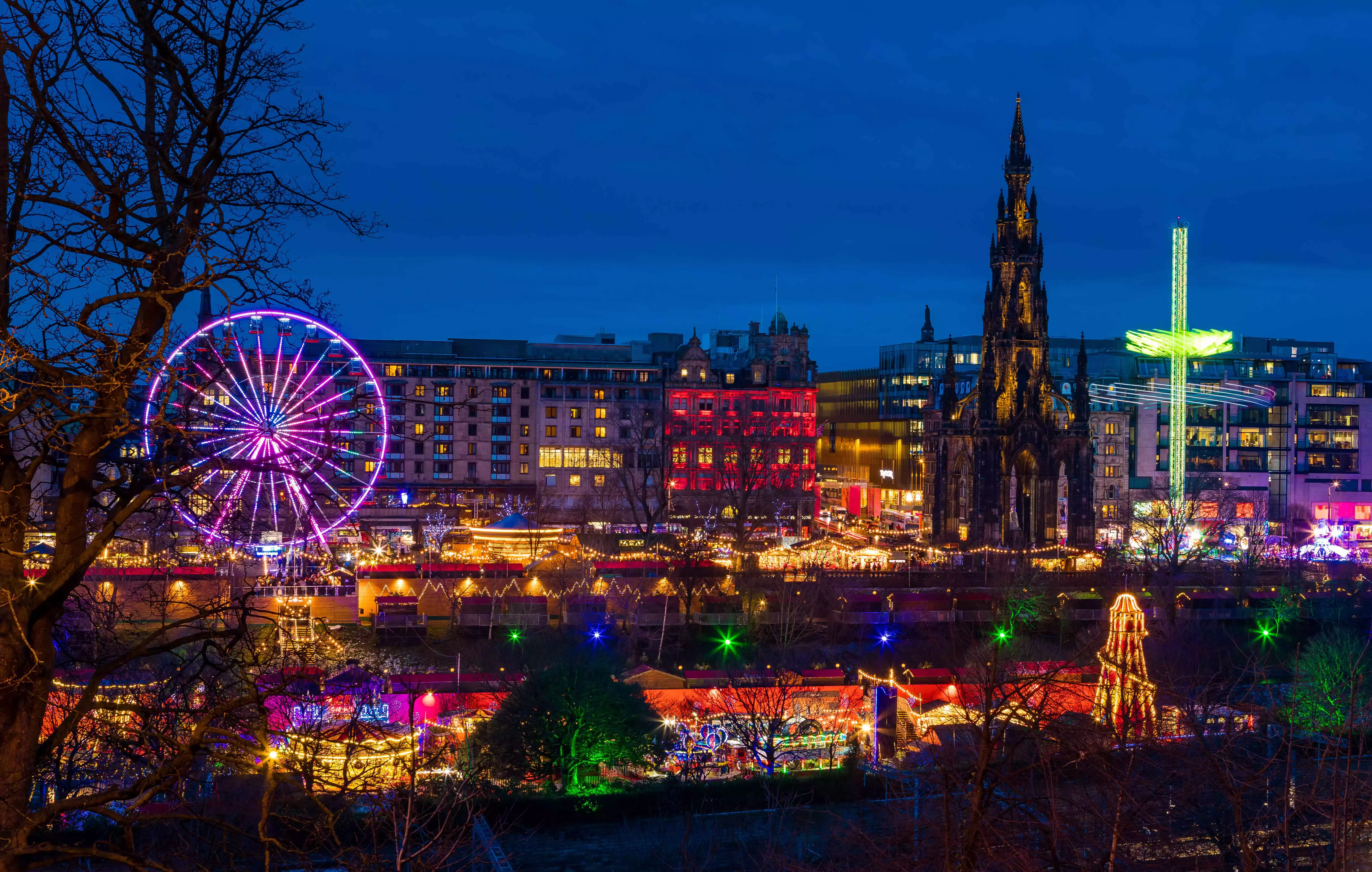Fairground rides and market stalls at Edinburgh&amp;amp;#039;s Christmas Market and Hogmanay fair in Edinburgh, Scotland.
