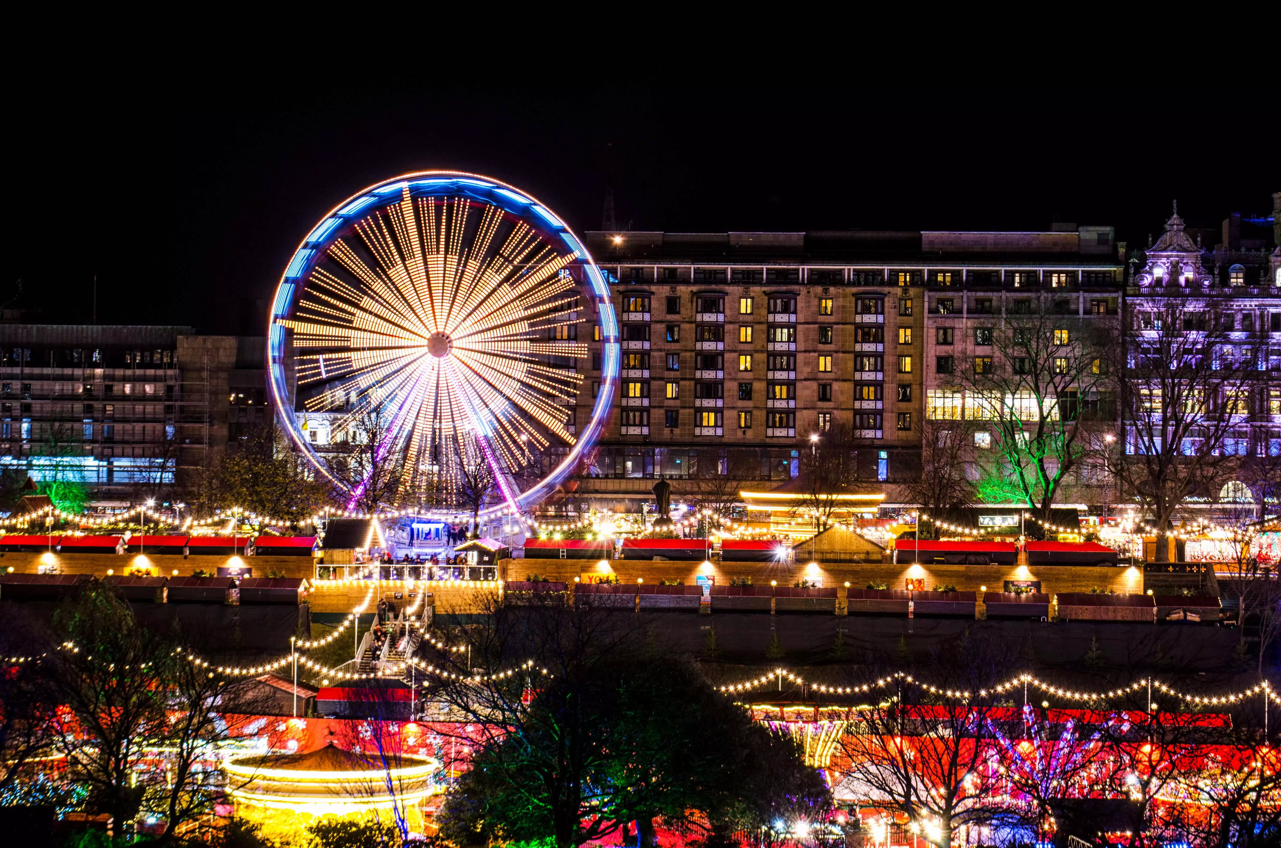 Christmas markets and giant ferris wheel in Edinburgh, Scotland, during Hogmanay and Christmas celebrations