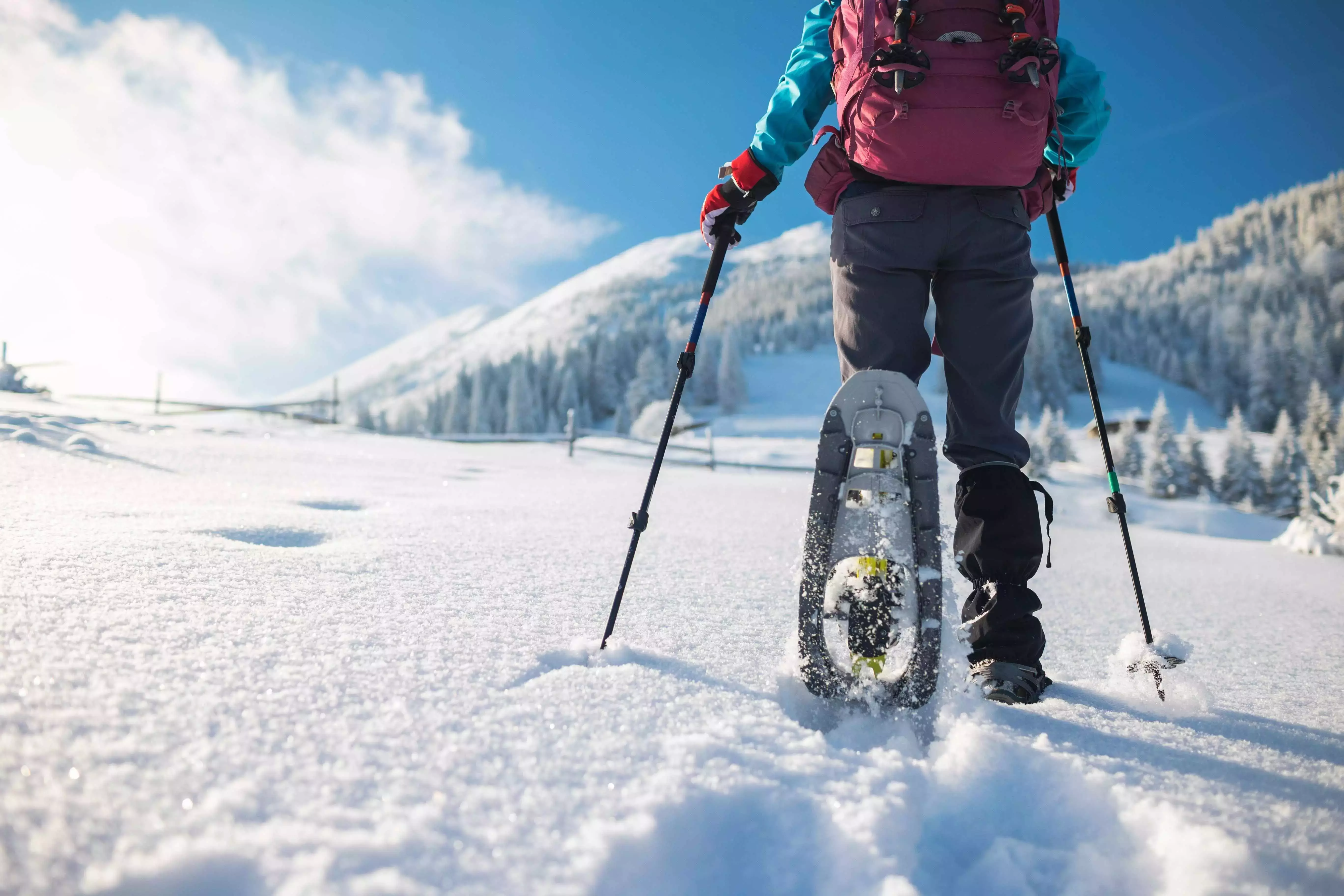 Someone walking through the snow with snowshoes on