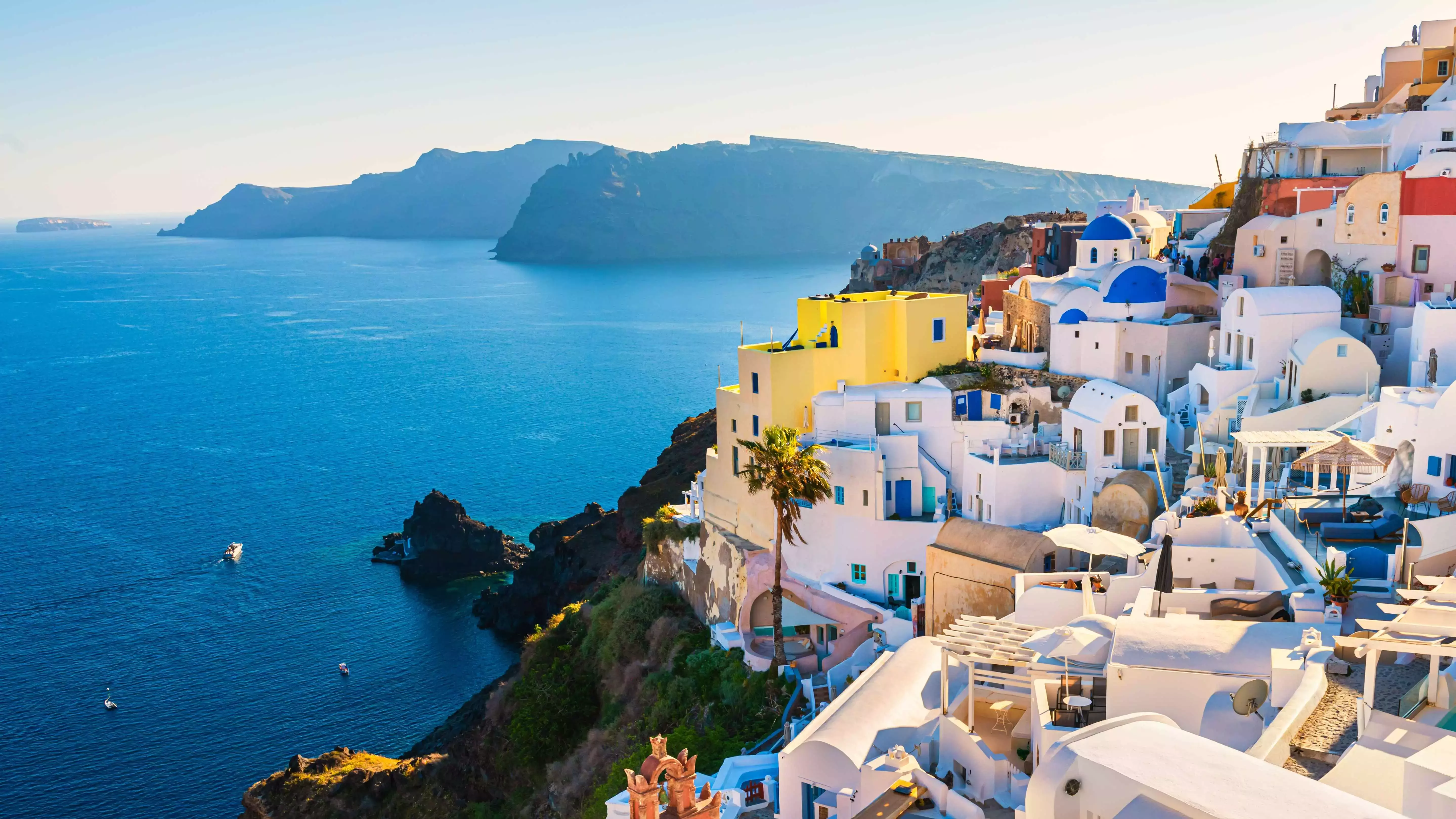 Classic whitewashed and blue-domed houses in Santorini, Greece.