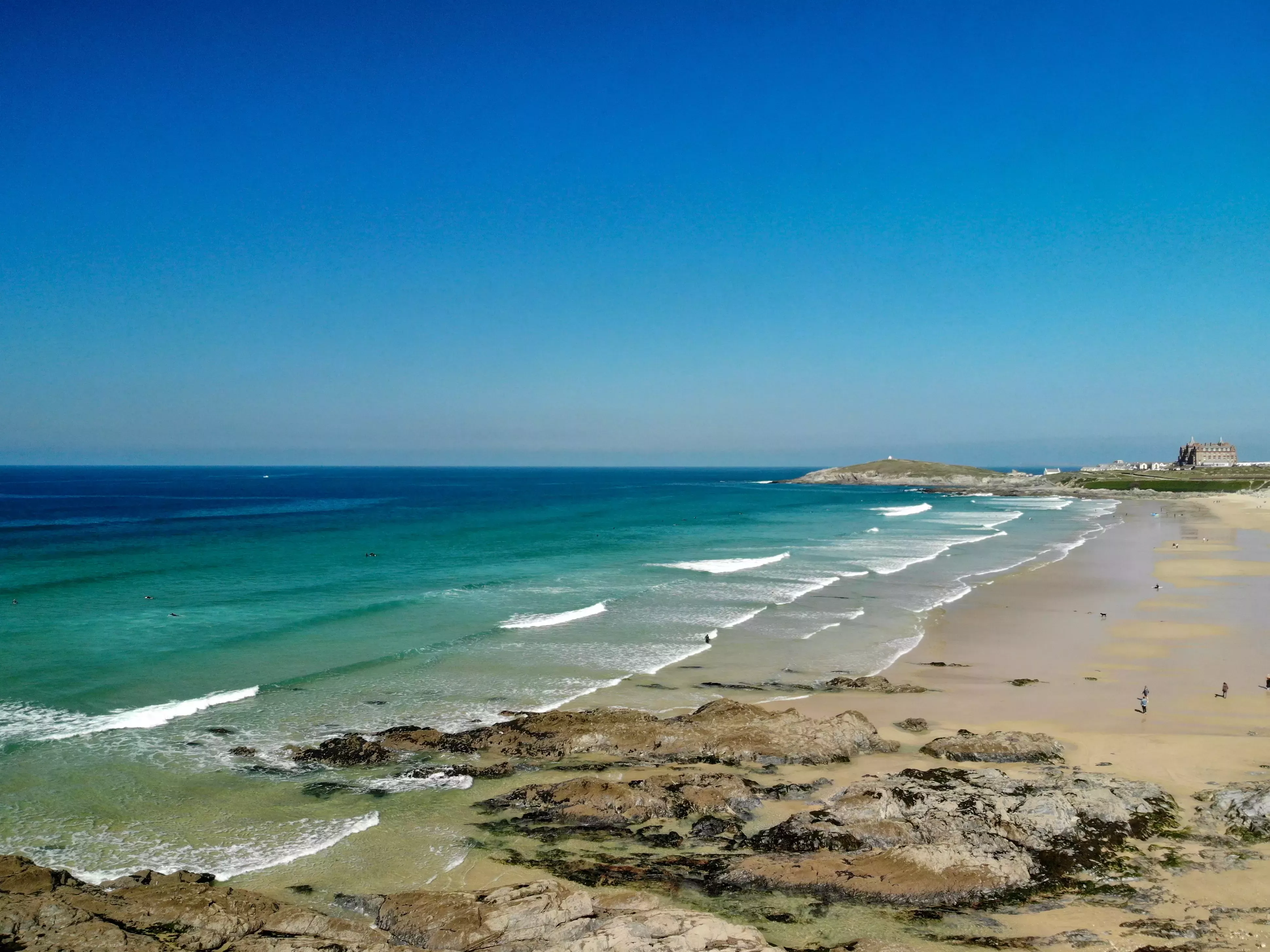 Aerial view of waves lapping onto Fistral Beach in Newquay, Cornwall