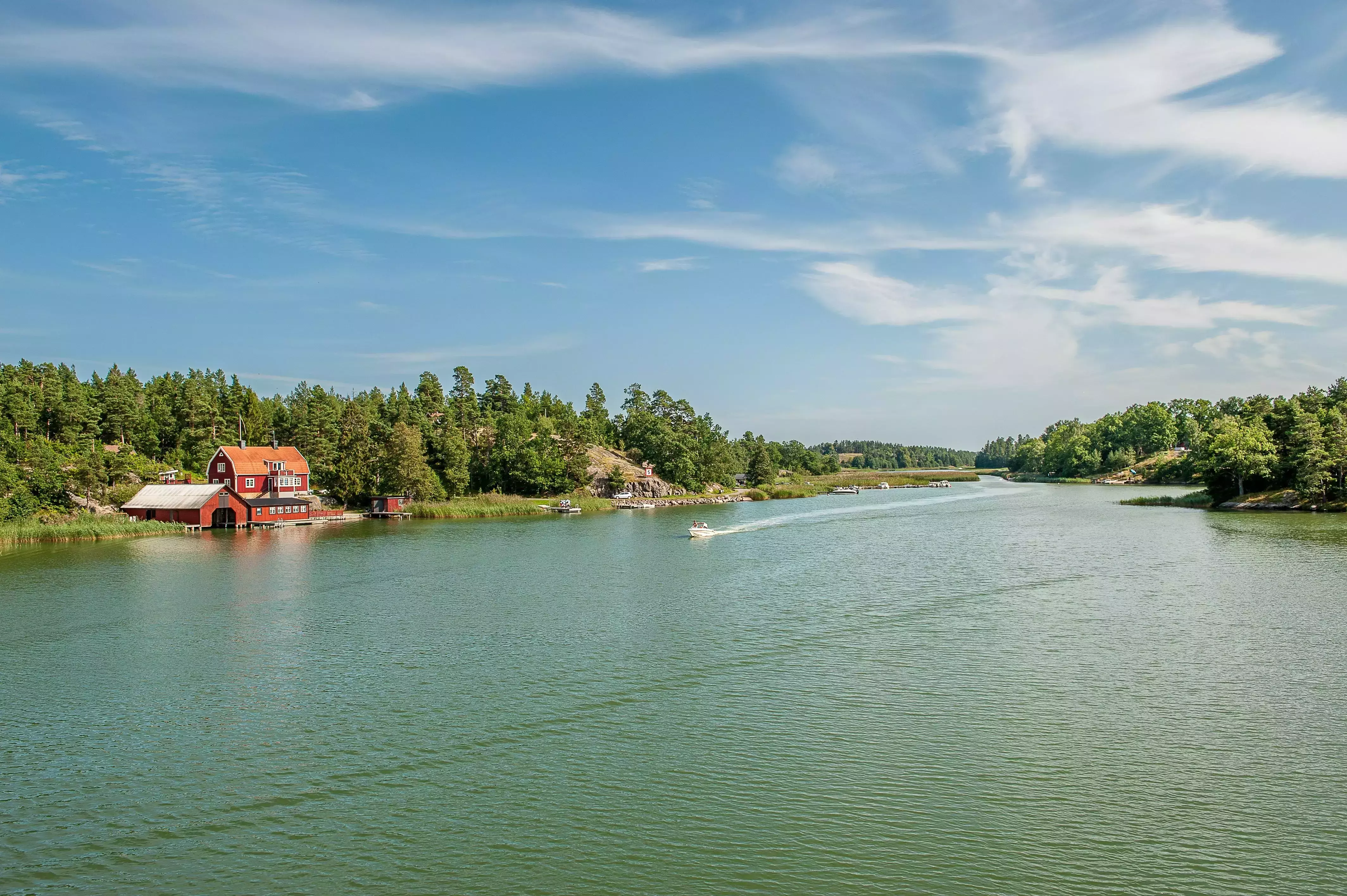 Gentle green blue waterway flanked by greenery in Sankt Anna Archipelago