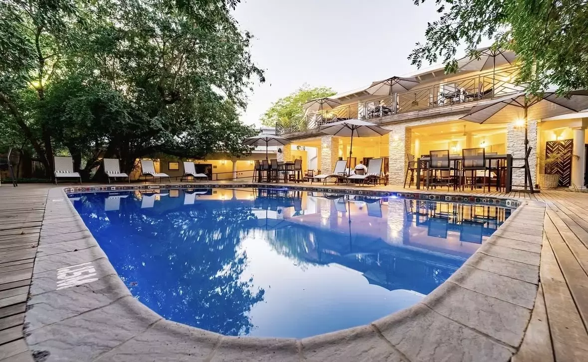 An eco-friendly resort with an outdoor pool near Victoria Falls.