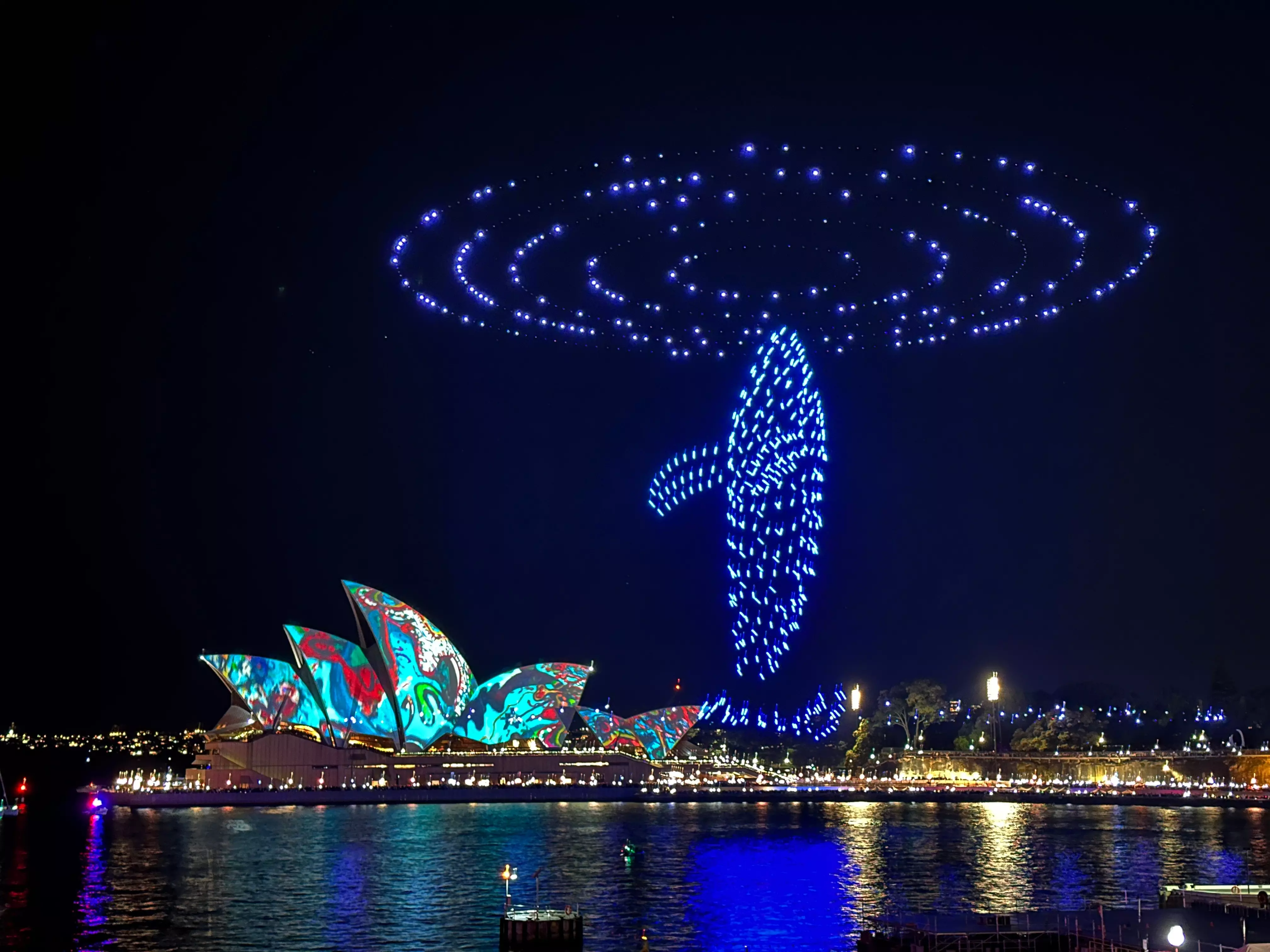 Vivid Sydney illuminating the night sky over the Harbour Bridge and Opera House.