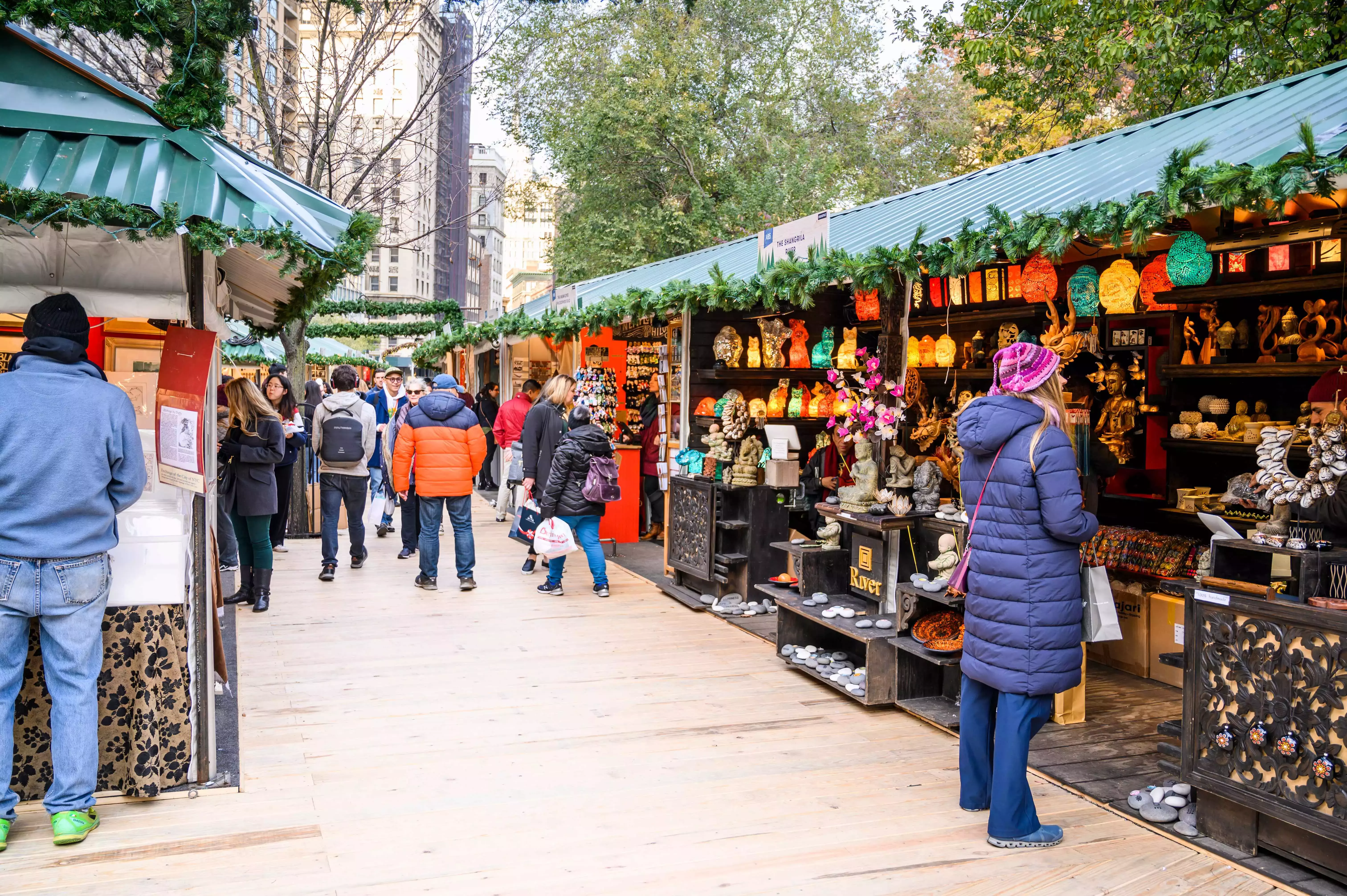 People exploring and shopping at Union Square Christmas Market in New York City.