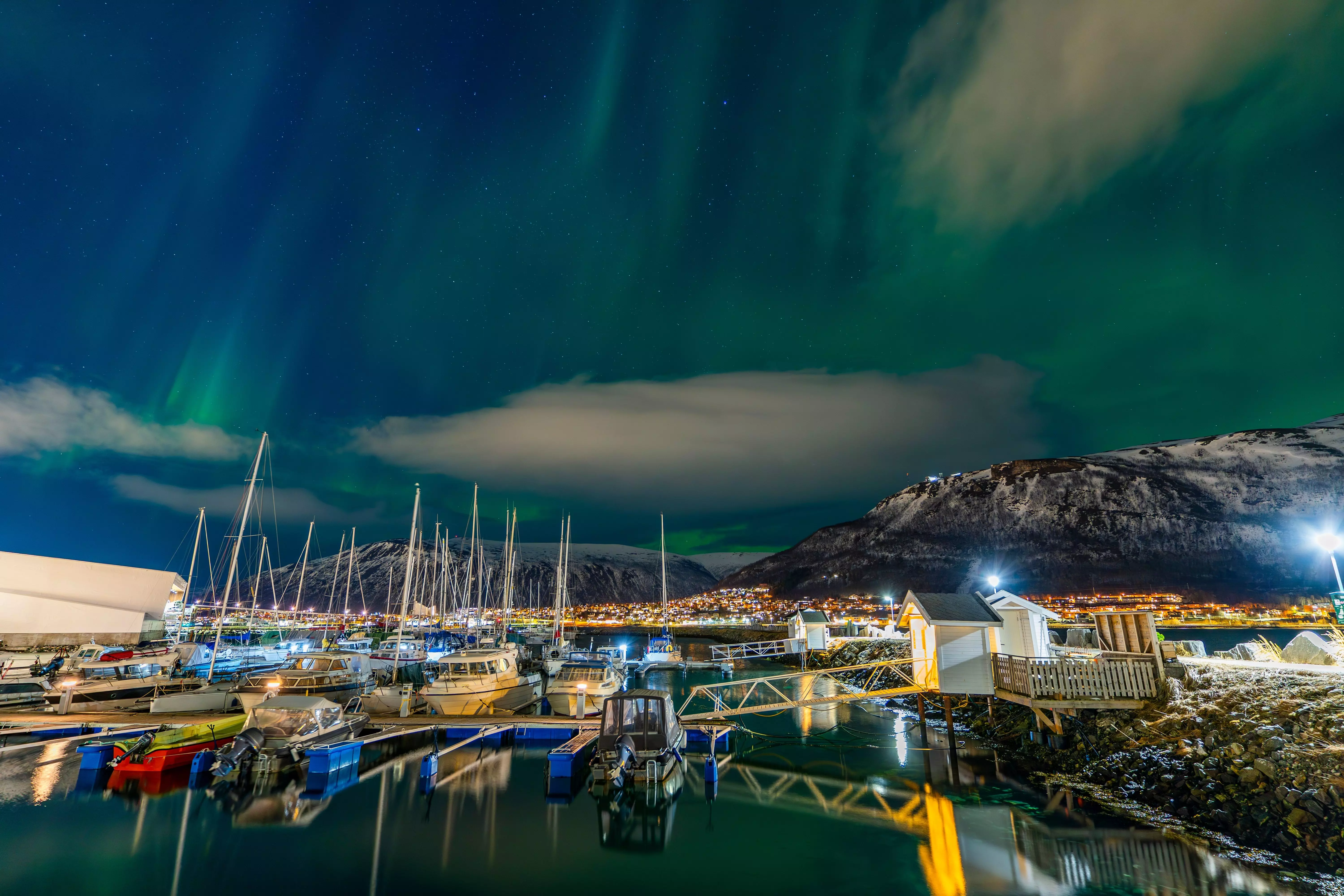 Spectacular Northern Lights displays over Troms&oslash; Harbour in the winter time.