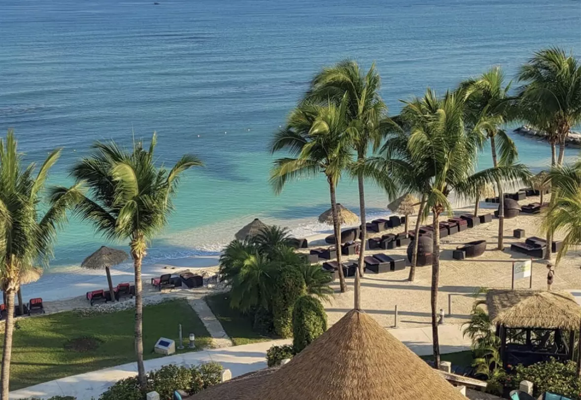 White-sand beaches and swaying palms at Secret St James, Montego Bay, Jamaica.