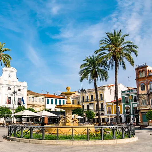 A Scenic View of Spain Square with a fountain in Merida