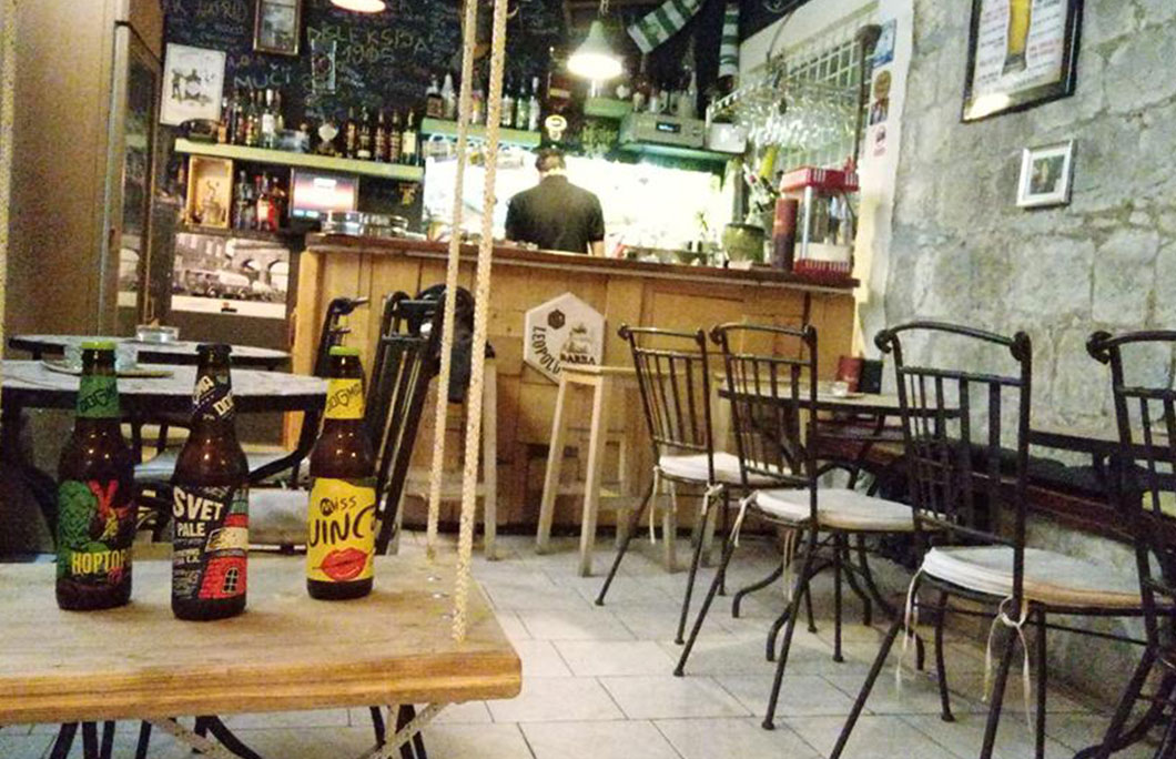 Bartender at the bar of the student pub 'Sehnsucht' in the