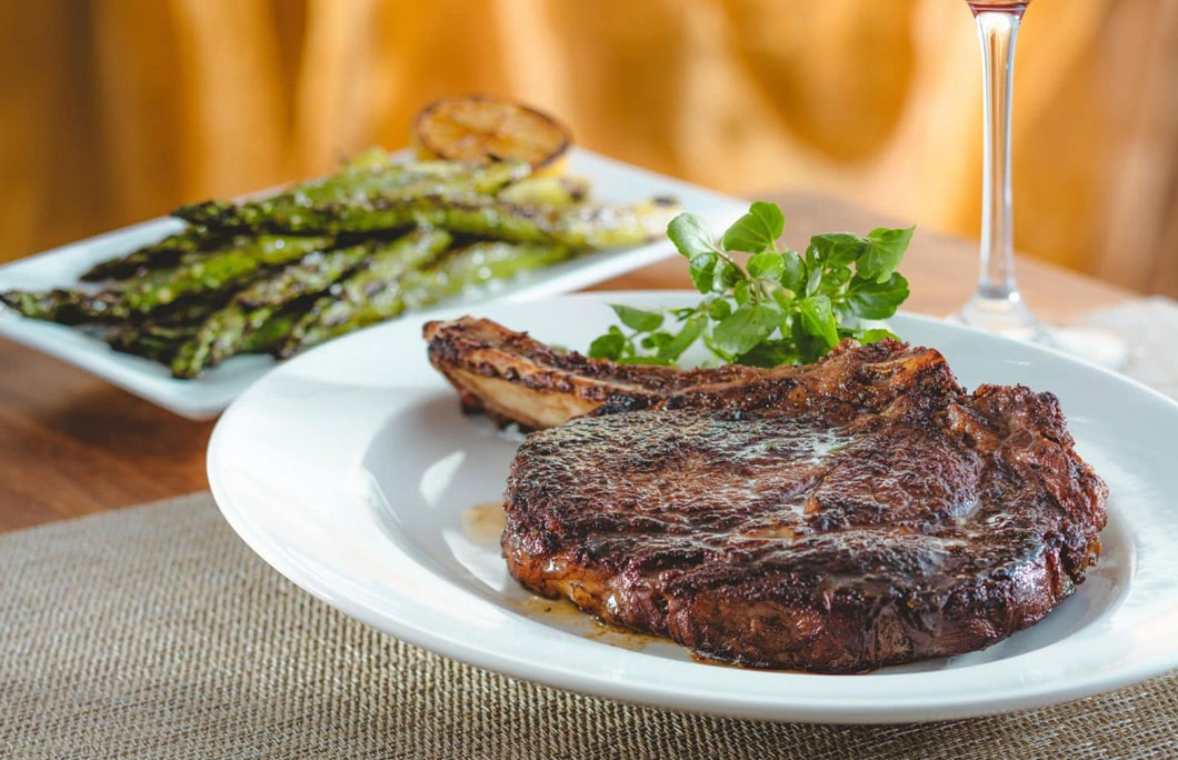 bone-in steak on a plate from The Capital Grille Steakhouse in New Jersey